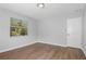 Bedroom with light wood floors, white walls, and bright natural light at 1961 Winter Park Rd, Winter Park, FL 32789