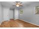 Bedroom featuring a ceiling fan, hardwood floors, and two windows with coverings at 1961 Winter Park Rd, Winter Park, FL 32789