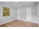 Bedroom with wood flooring, neutral walls, and bright window with privacy blinds at 1961 Winter Park Rd, Winter Park, FL 32789
