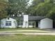 Charming single-story home features a well-maintained lawn and classic white-painted brick facade at 1961 Winter Park Rd, Winter Park, FL 32789