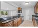 Well-lit kitchen featuring black countertops, wood cabinets, and black appliances at 1961 Winter Park Rd, Winter Park, FL 32789