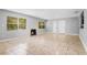 Bright living room with tile floors, a decorative fireplace, and abundant natural light at 1961 Winter Park Rd, Winter Park, FL 32789