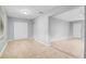 Neutral-toned living room featuring tile floors, a closet, and an entryway with views into the kitchen at 1961 Winter Park Rd, Winter Park, FL 32789