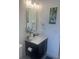 Nicely appointed bathroom with sleek vanity, modern fixtures, and decorative waterfall art at 2011 E Esther St, Orlando, FL 32806