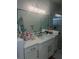 Bathroom featuring an extended vanity with double sinks, black hardware, and bright lighting at 2011 E Esther St, Orlando, FL 32806