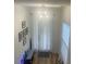 Bright entryway with modern light fixture, stylish decor, and gleaming hardwood floors at 2011 E Esther St, Orlando, FL 32806
