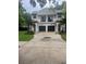 Two-story home with private garages and balconies with black railings at 2011 E Esther St, Orlando, FL 32806