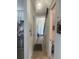 Hallway leads to dining and living spaces; staircase with black railing is visible at 2011 E Esther St, Orlando, FL 32806