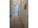Hallway with clean, white walls, neutral carpet, and access to other rooms at 2011 E Esther St, Orlando, FL 32806