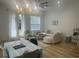 Cozy living space with a dining table, soft couch, and doors leading to backyard at 2011 E Esther St, Orlando, FL 32806