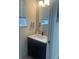 Stylish powder room with a modern black vanity and chic mirror at 2011 E Esther St, Orlando, FL 32806