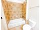 Tiled bathroom with a shower-tub combo, white fixtures, and a clean design for a functional space at 2404 Bella Vista Dr, Davenport, FL 33897