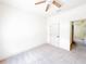 Bright carpeted bedroom with ceiling fan, base trim and doorway to open hallway at 2404 Bella Vista Dr, Davenport, FL 33897