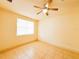 Bright bedroom featuring tile floors, ceiling fan, base trim and a large window at 2404 Bella Vista Dr, Davenport, FL 33897