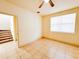 Bedroom featuring tile floors, base trim, large window, ceiling fan and open doorway to hallway at 2404 Bella Vista Dr, Davenport, FL 33897