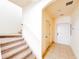Bright entryway with tile flooring, leading to a staircase with neutral carpet and a white front door at 2404 Bella Vista Dr, Davenport, FL 33897