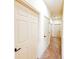 Bright hallway with neutral carpet and multiple paneled doors, offering access to various rooms at 2404 Bella Vista Dr, Davenport, FL 33897