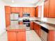 Well-equipped kitchen features granite countertops, stainless steel appliances, and cherry wood cabinetry at 2404 Bella Vista Dr, Davenport, FL 33897