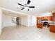 Open-concept living space with tile flooring seamlessly connects the kitchen and living areas at 2404 Bella Vista Dr, Davenport, FL 33897