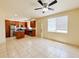 Expansive living room with tile flooring and natural light, adjacent to the kitchen at 2404 Bella Vista Dr, Davenport, FL 33897