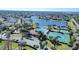 Aerial view of the community with a pool, tennis courts, a pond and mature trees at 2543 Chapala Dr, Kissimmee, FL 34746