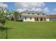 Large back yard behind a two-story home with covered patio at 2543 Chapala Dr, Kissimmee, FL 34746