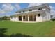 Lush backyard featuring ample grass and a view of the home's extended patio at 2543 Chapala Dr, Kissimmee, FL 34746
