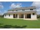 Expansive backyard view featuring a white home and ample green space at 2543 Chapala Dr, Kissimmee, FL 34746