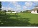 Large backyard with mature trees, ample green space and a play area at 2543 Chapala Dr, Kissimmee, FL 34746