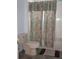 Bathroom with neutral finishes and a shower/tub combo with patterned shower curtain at 2543 Chapala Dr, Kissimmee, FL 34746