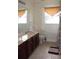 Bathroom featuring a vanity, a floral design on the walls, a window, and a shower and tub combo at 2543 Chapala Dr, Kissimmee, FL 34746