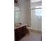 Clean bathroom featuring a tiled shower, vanity with granite countertop, and tile flooring at 2543 Chapala Dr, Kissimmee, FL 34746