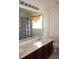 Bathroom featuring a vanity with double sinks, a mirror, floral wallpaper, and a shower and tub combo at 2543 Chapala Dr, Kissimmee, FL 34746