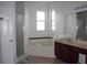 Bathroom featuring a glass shower, large soaking tub, and a vanity with generous counter space at 2543 Chapala Dr, Kissimmee, FL 34746