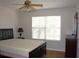 Bedroom with a ceiling fan, bed, window with horizontal blinds, and dresser at 2543 Chapala Dr, Kissimmee, FL 34746