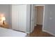 Bedroom featuring wood-look floors, with view of closet and door leading to hallway at 2543 Chapala Dr, Kissimmee, FL 34746