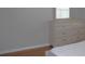 Bedroom featuring wood-look floors, a dresser and a window with blinds at 2543 Chapala Dr, Kissimmee, FL 34746