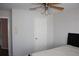 Bright bedroom featuring a ceiling fan, door and bed frame at 2543 Chapala Dr, Kissimmee, FL 34746