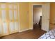 Bedroom boasts a closet and door leading to hallway, complimented with wood-look floors at 2543 Chapala Dr, Kissimmee, FL 34746