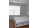 Bedroom features wood-look floors, ceiling fan and a window with white blinds at 2543 Chapala Dr, Kissimmee, FL 34746