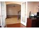 An entryway with french doors leading to an office, hardwood floors, and neutral color walls at 2543 Chapala Dr, Kissimmee, FL 34746