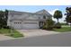 Beautiful two-story house featuring a spacious three-car garage, lovely landscaping, and a well-maintained lawn at 2543 Chapala Dr, Kissimmee, FL 34746