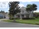 Inviting two-story home with a covered entrance, lush landscaping, a well-kept lawn, and a charming curb appeal at 2543 Chapala Dr, Kissimmee, FL 34746