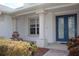 Covered front porch features a fountain, columns and blue front doors at 2543 Chapala Dr, Kissimmee, FL 34746