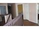 Hallway view from the top of the stairs showing the bedrooms and stairway at 2543 Chapala Dr, Kissimmee, FL 34746