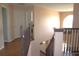 Hallway featuring hardwood floors, railing overlooking the stairs, and views through several doorways at 2543 Chapala Dr, Kissimmee, FL 34746