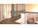 Hallway with wood flooring and wooden stair railing with doors on either side of the frame at 2543 Chapala Dr, Kissimmee, FL 34746