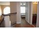Hallway with wood flooring, natural light, staircase and doorway views of bedroom and bathroom at 2543 Chapala Dr, Kissimmee, FL 34746