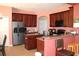 Traditional-style kitchen with stainless steel refrigerator and granite countertops at 2543 Chapala Dr, Kissimmee, FL 34746
