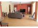 Spacious living room with modern flooring, a comfortable leather sofa, and abundant natural light at 2543 Chapala Dr, Kissimmee, FL 34746